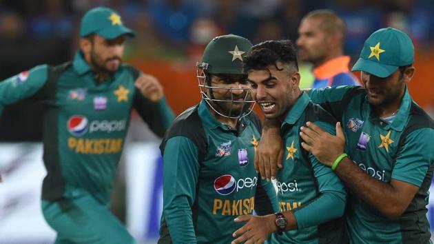 Pakistan cricketer Shadab Khan (2R) celebrates with teammates after he dismissed unseen Indian cricket team captain Rohit Sharma. (AFP)