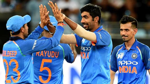 Indian cricketer Jasprit Bumrah (2R) celebrates with teammates after dismissing Pakistan batsman Usman Khan. (AFP)