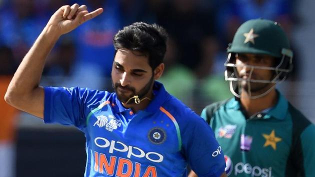 Indian cricketer Bhuvneshwar Kumar celebrates after he dismissed Pakistan batsman Imam-ul-Haq. (AFP)