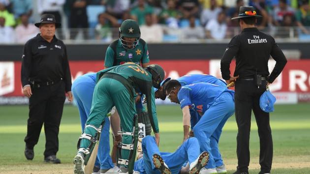 India all-rounder Hardik Pandya lies on his back after getting injured during the Asia Cup game against Pakistan in Dubai.(AFP)