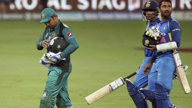 Pakistan's captain Sarfraz Ahmed, left, leaves the field followed by India's Dinesh Karthik, right, and Ambati Rayudu at the end of the one day international cricket match. (AP)