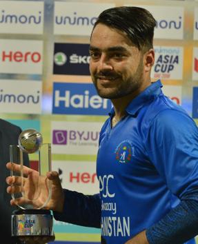 Afghan cricketer Rashid Khan poses with his award of 'Player Of The Match' after victory in the one day international (ODI) Asia Cup cricket match between Bangladesh and Afghanistan at The Sheikh Zayed Stadium in Abu Dhabi . (AFP)