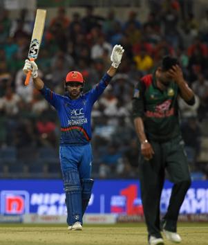 Afghan batsman Rashid Khan (L) celebrates after scoring a half-century (50 runs) as Bangladesh Cricket captain Mashrafe Mortaza (R) during the one day international (ODI) Asia Cup cricket match between Bangladesh and Afghanistan at the Sheikh Zayed Stadium in Abu Dhabi. (AFP)