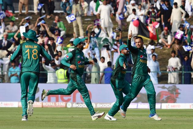 Pakistan's Mohammad Nawaz (R) celebrates after he dismissed Afghan batsman Mohammad Shahzad. (AFP)