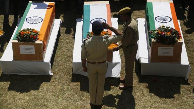 A police officer pays his respects to fallen colleagues at a base camp at Shopian on Friday. Anti-India rebels in Kashmir raided over a dozen homes of police officers and abducted three whose bullet-riddled bodies were recovered Friday, officials said. The killings came days after the region's largest rebel group asked officers to quit the police force and stay away from counter insurgency operations. (Mukhtar Khan / AP) A police officer pays his respects to fallen colleagues at a base camp at Shopian on Friday. Anti-India rebels in Kashmir raided over a dozen homes of police officers and abducted three whose bullet-riddled bodies were recovered Friday, officials said. The killings came days after the region's largest rebel group asked officers to quit the police force and stay away from counter insurgency operations. (Mukhtar Khan / AP)