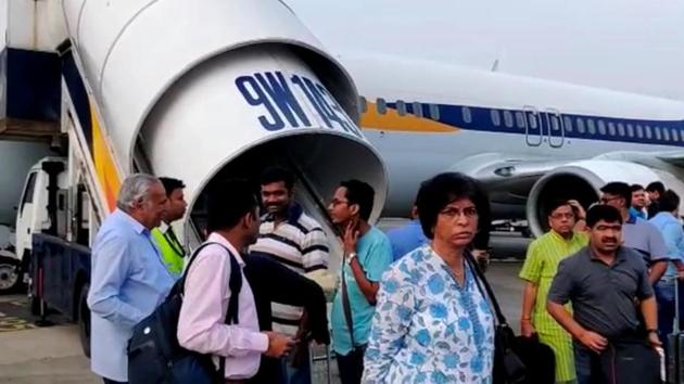 Passengers stand on the tarmac after an emergency landing, due to lost cabin pressure, on a Jet Airways flight, in Mumbai, India September 20, 2018 in this still image obtained from social media video.(Melissa Tixiera via Reuters)