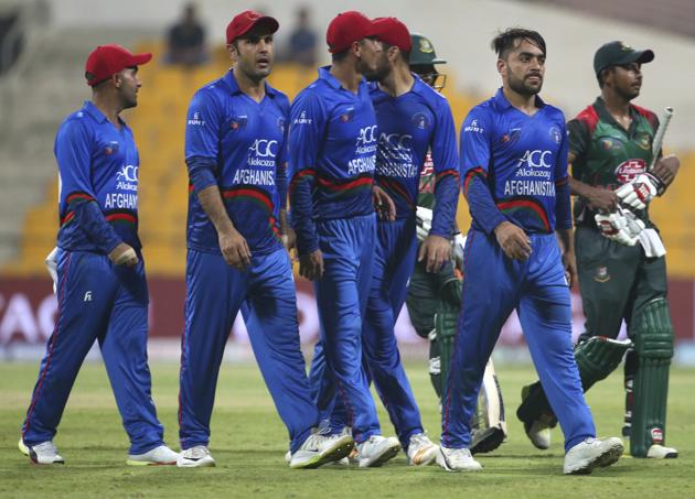 Afghanistan's Rashid Khan, second right, leaves the field with teammates and Bangladesh batsmen, in green jerseys, after their win in the one day international cricket match of Asia Cup between Bangladesh and Afghanistan in Abu Dhabi. (AP)