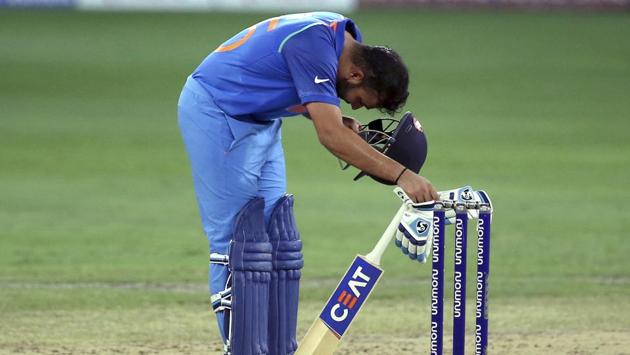India’s standing captain Rohit Sharma bends to remove his helmet to wipe off sweat during the one day international cricket match of Asia Cup between India and Pakistan in Dubai, United Arab Emirates on September 19, 2018. (Aijaz Rahi / AP) India’s standing captain Rohit Sharma bends to remove his helmet to wipe off sweat during the one day international cricket match of Asia Cup between India and Pakistan in Dubai, United Arab Emirates on September 19, 2018. (Aijaz Rahi / AP)