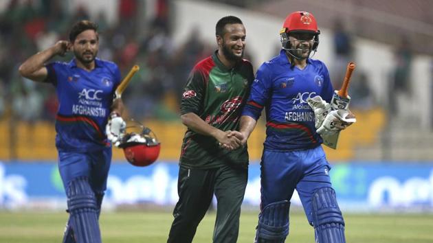 Bangladesh's Shakib Al Hasan, center, congratulates Afghanistan's Rashid Khan, right, on scoring fifty runs during the one day international cricket match of Asia Cup between Bangladesh and Afghanistan in Abu Dhabi. (AP)