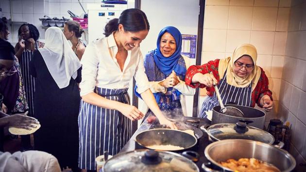Meghan, Duchess of Sussex, cooks with women in the Hubb Community Kitchen at the Al Manaar Muslim Cultural Heritage Centre in West London, in the aftermath of the Grenfell Tower fire. (Jenny Zarins / Kensington Palace / AFP)