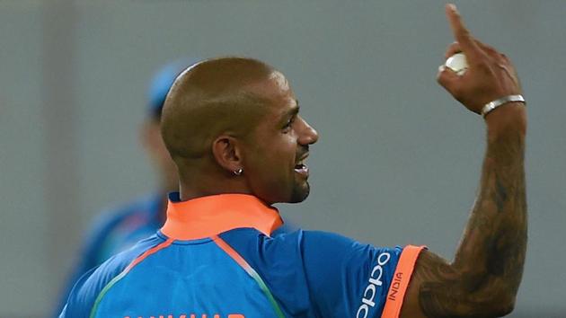 Indian cricketer Shikhar Dhawan celebrates after dismissing Bangladesh batsman Mustafizur Rahman. (AFP)