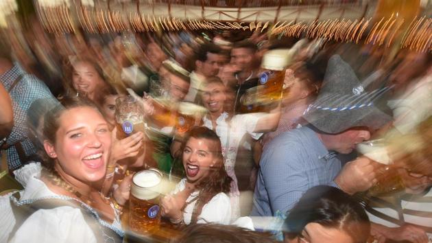 People celebrate with beers after the official opening of the 185th Oktoberfest, Munich's annual beer festival in Munich,Germany. (Christof Stache / AFP) People celebrate with beers after the official opening of the 185th Oktoberfest, Munich's annual beer festival in Munich,Germany. (Christof Stache / AFP)