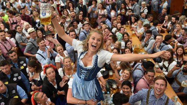 Visitors celebrate as they drink beer during the Munich's annual beer festival. (Christof Stache / AFP) Visitors celebrate as they drink beer during the Munich's annual beer festival. (Christof Stache / AFP)