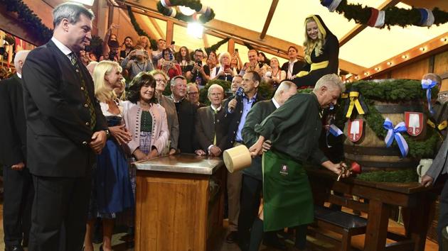 Markus Soeder, governor of the German state of Bavaria, attends the tapping of the first barrel of beer by Munich's mayor Dieter Reiter as part of the opening of the fest. (Peter Kneffel / AP) Markus Soeder, governor of the German state of Bavaria, attends the tapping of the first barrel of beer by Munich's mayor Dieter Reiter as part of the opening of the fest. (Peter Kneffel / AP)