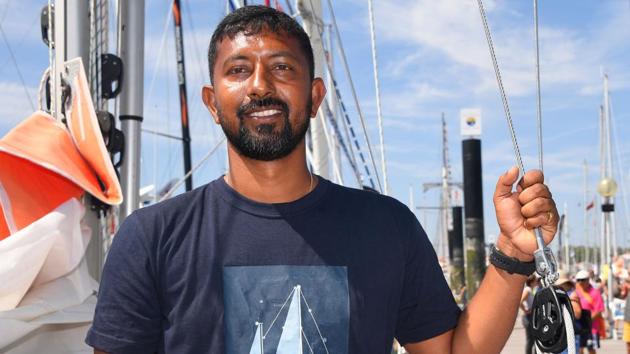 Abhilash Tomy poses on his boat ‘Thuriya’ in Les Sables d'Olonne Harbour, on June 29, 2018, ahead of the solo around-the-world sailing race for the ‘Golden Globe Race’ ocean race in which sailors compete without high technology aides such as GPS or computers.(AFP)