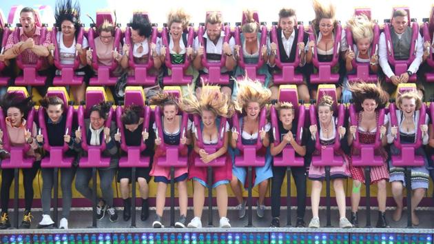 Visitors ride a roller coaster during the opening day of the fest.The public festivities on the Theresienwiese open ground - named after the bride - became more elaborate as time went on, with stalls and amusement rises and it gradually turned into a folk festival. (Michael Dalder / REUTERS) Visitors ride a roller coaster during the opening day of the fest.The public festivities on the Theresienwiese open ground - named after the bride - became more elaborate as time went on, with stalls and amusement rises and it gradually turned into a folk festival. (Michael Dalder / REUTERS)
