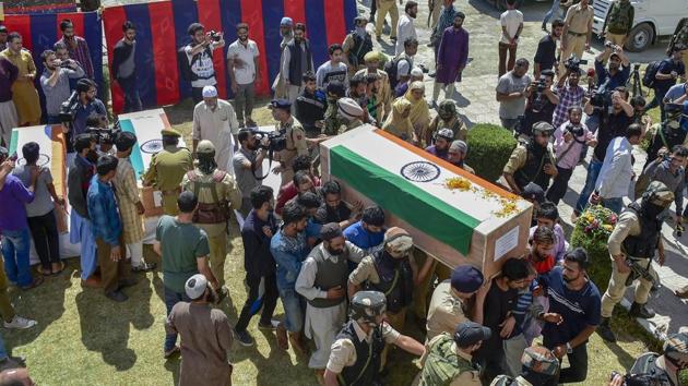Police officers and relatives shoulder the coffin of the slain police constable Nissar Ahmad Dhobi after a wreath laying ceremony in Shopian on September 21. (PTI Photo) Police officers and relatives shoulder the coffin of the slain police constable Nissar Ahmad Dhobi after a wreath laying ceremony in Shopian on September 21. (PTI Photo)