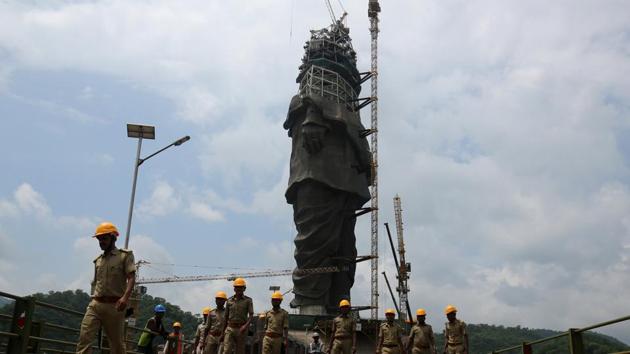 Policemen walk past the under construction ‘Statue of Unity’ portraying Sardar Vallabhbhai Patel, one of the founding fathers of India, during a media tour in Kevadiya in Gujarat.(Reuters Photo)