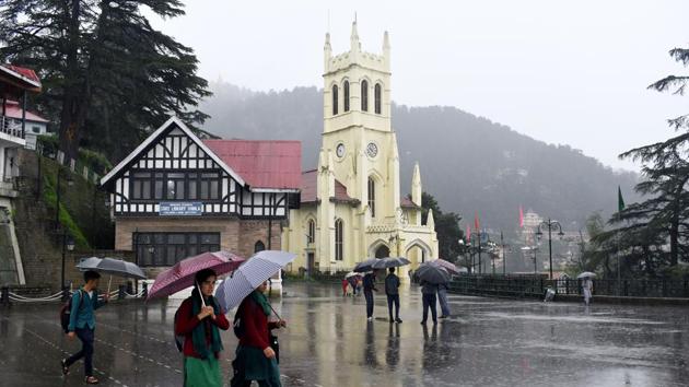 People take a stroll with umbrellas during rain at Ridge, Shimla on Saturday, September 22. 2018.(Deepak Sansta / Hindustan Times)