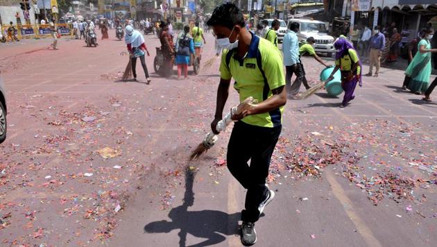 PMC workers and NGO volunteers clean the roads after the Ganesh visarjan procession on Sunday. (ht photo) 