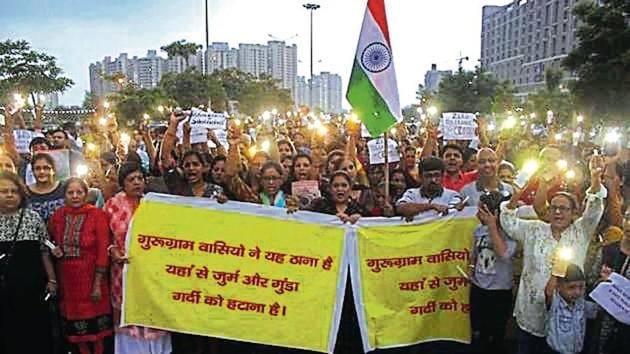 Residents of Sectors 82, 83 and 86 took out a candle-light march, demanding better policing.(HT Photo)