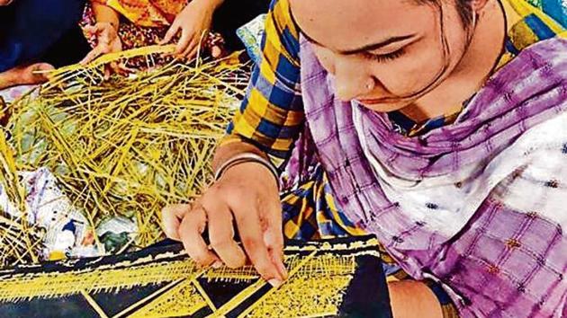 A student preparing a wall hanging from crop waste at PAU in Ludhiana.(HT Photo)