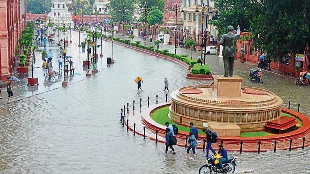 Commuters making their way through the flooded Heritage Street; and (below) portion of a road that caved in near the municipal commissioner’s house in Amritsar on Sunday. (HT Photo) Commuters making their way through the flooded Heritage Street; and (below) portion of a road that caved in near the municipal commissioner’s house in Amritsar on Sunday. (HT Photo)