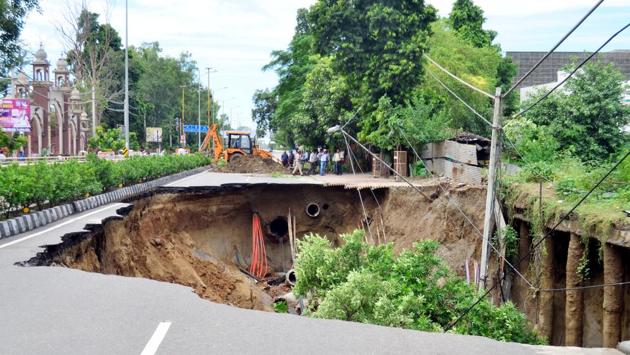 In Amritsar, a large section of the Mall Road near the MC Commissioner’s office caved in due to heavy rain. Two persons were killed in a roof collapse in Nawanshahr district in Punjab, around 90 km from here, on Sunday. (Sameer Sehgal/ht)