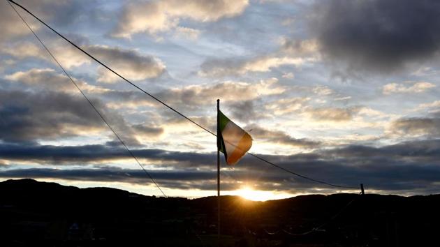 The Irish tricolour flutters as the sun rises along the border between in Newry. The EU Withdrawal Act of 2018 declares the UK will exit the EU on the March 29, 2019. The frontier between Northern Ireland and the Republic of Ireland runs for 310 miles and is the only border between the UK and the EU. (Charles McQuillan / Getty Images) The Irish tricolour flutters as the sun rises along the border between in Newry. The EU Withdrawal Act of 2018 declares the UK will exit the EU on the March 29, 2019. The frontier between Northern Ireland and the Republic of Ireland runs for 310 miles and is the only border between the UK and the EU. (Charles McQuillan / Getty Images)