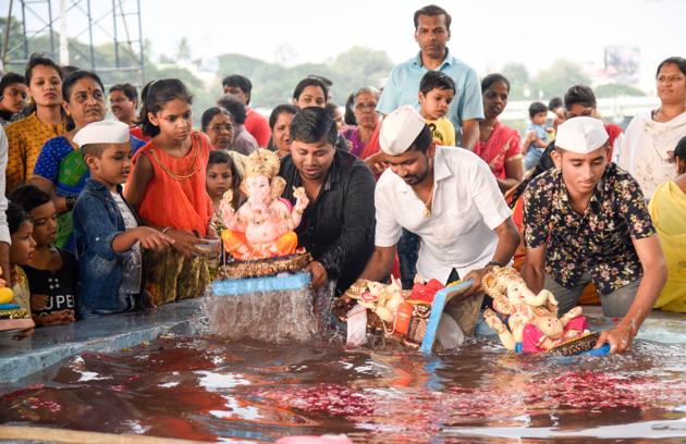 Residents immerse their Ganesh idols in an ecofriendly pond near Garware College on Sunda. (Sanket Wankhade/ ht photo) Residents immerse their Ganesh idols in an ecofriendly pond near Garware College on Sunda. (Sanket Wankhade/ ht photo)