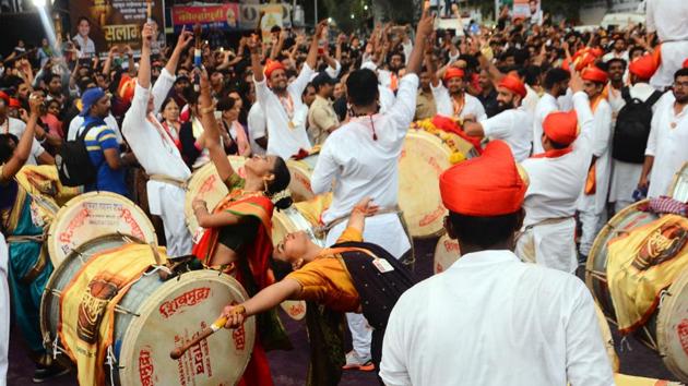 Members of a dhol tasha pathak playing their music sequence during the Ganesh idol immersion procession at Alka Talkies chowk on Sunday. (Shankar Narayan/HT PHOTO) Members of a dhol tasha pathak playing their music sequence during the Ganesh idol immersion procession at Alka Talkies chowk on Sunday. (Shankar Narayan/HT PHOTO)