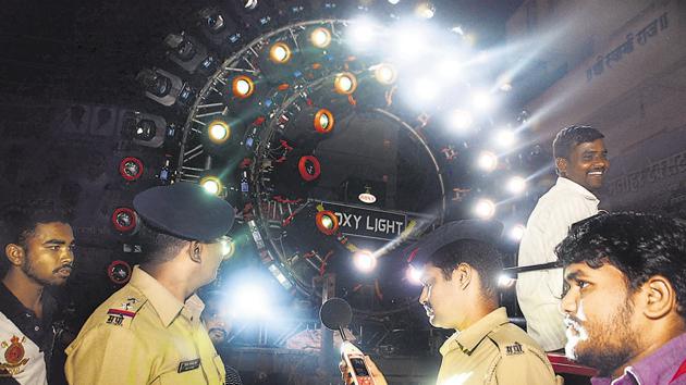 Police personnel check the noise during the immersion procession of a Ganpati mandal with a decibel measuring device in Pune, on Friday. (Shankar Narayan/HT PHOTO) Police personnel check the noise during the immersion procession of a Ganpati mandal with a decibel measuring device in Pune, on Friday. (Shankar Narayan/HT PHOTO)