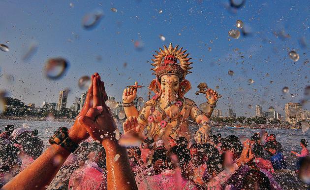 Devotees thronged Girgaum Chowpatty, one of the major immersion points in the city.(HT Photo)