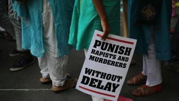 A protestor stands with a placard during a protest against two recently reported rape cases as they gather near the Indian parliament in New Delhi, India(AP File Photo)