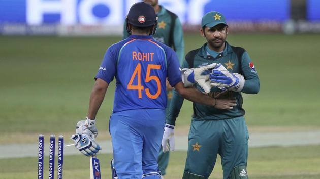 India's captain Rohit Sharma, left, greets Pakistan's captain Sarfraz Ahmed as they leave the field at the end of the one day international cricket match of Asia Cup between India and Pakistan in Dubai(AP)