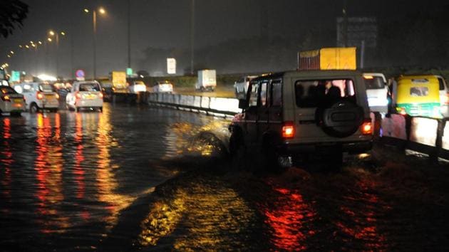 A view of waterlogged street at Delhi-Gurugram expressway service lane near CNG filling station after heavy rain, at Sector31, in Gurugram, India, on Sunday(HT Photo)