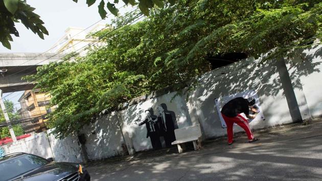 After the clock image went viral, police attempted to monitor the artist and city officials hit the streets to paint over subversive graffiti. Prawit insists the watches were borrowed from friends, but nine months later Thailand’s anti-graft body has yet to finish its investigation. Headache again stole the spotlight in March -- this time with graffiti showing a black panther crying tears of blood. (Romeo Gacad / AFP) After the clock image went viral, police attempted to monitor the artist and city officials hit the streets to paint over subversive graffiti. Prawit insists the watches were borrowed from friends, but nine months later Thailand’s anti-graft body has yet to finish its investigation. Headache again stole the spotlight in March -- this time with graffiti showing a black panther crying tears of blood. (Romeo Gacad / AFP)