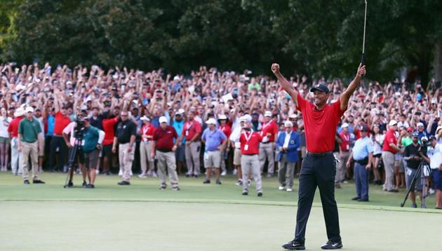 Tiger Woods of the United States celebrates making a par on the 18th green to win the TOUR Championship at East Lake Golf Club on September 23, 2018 in Atlanta, Georgia.(AFP)