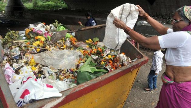 Woman collects the nirmalaya used during the Ganesh festival on Sunday. (ht photo) 
