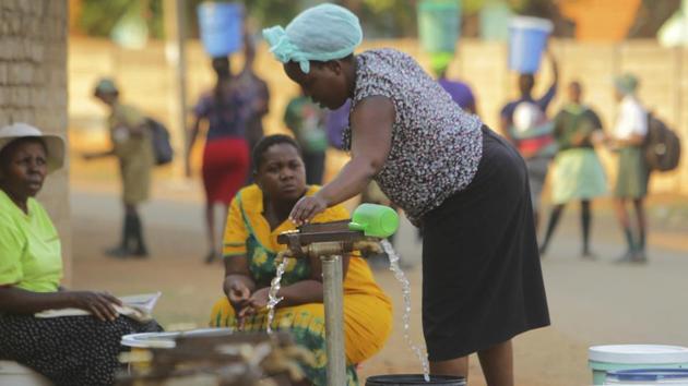 People collect treated water at a watering point in Harare. Finance Minister Mthuli Ncube’s crowd-funding initiative swelled public anger, with some questioning why a government that splashes on new cars and private jets should ask impoverished citizens to chip in. If quick intervention by donors and the government comes, it can help Zimbabwe avoid a repeat of the 2008 disaster but they agree risks remain if long-term measures aren’t taken. (Tsvangirayi Mukwazhi / AP) People collect treated water at a watering point in Harare. Finance Minister Mthuli Ncube’s crowd-funding initiative swelled public anger, with some questioning why a government that splashes on new cars and private jets should ask impoverished citizens to chip in. If quick intervention by donors and the government comes, it can help Zimbabwe avoid a repeat of the 2008 disaster but they agree risks remain if long-term measures aren’t taken. (Tsvangirayi Mukwazhi / AP)