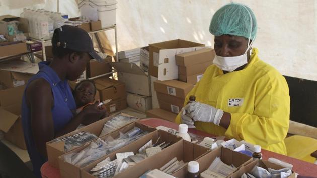 A mother receives treatment for her child suspected of suffering from cholera. Corruption has flourished amid the crisis. The Harare City Council said it suspended several officials after billionaire businessman Strive Masiyiwa wrote on Facebook that officials had inflated prices after his firm donated $10 million to buy medicine and health materials. Other crises are piling up with factories resembling scrapyards. (Tsvangirayi Mukwazhi / AP) A mother receives treatment for her child suspected of suffering from cholera. Corruption has flourished amid the crisis. The Harare City Council said it suspended several officials after billionaire businessman Strive Masiyiwa wrote on Facebook that officials had inflated prices after his firm donated $10 million to buy medicine and health materials. Other crises are piling up with factories resembling scrapyards. (Tsvangirayi Mukwazhi / AP)