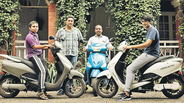 (From left to right) Vaibhav Kankhar, Class 10 student; Edward Pereira, owner, Dutch Palace; Edward’s manager Ravi Kankhar and Edward’s son Nathan Pereira with their electric bikes at Dutch Palace on Monday.(Saumya James/HT PHOTO)