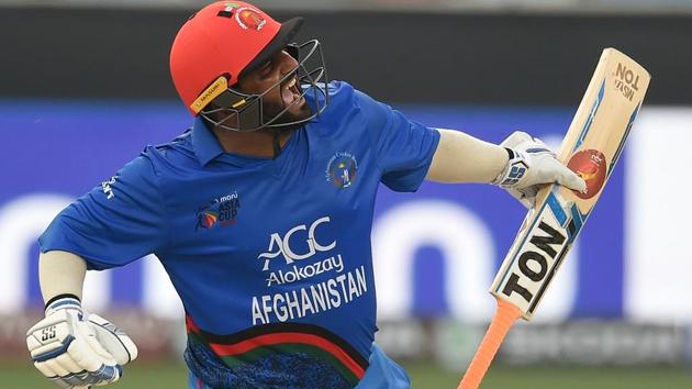 Afghan batsman Mohammad Shahzad celebrates after scoring a century (100 runs) during the one day international (ODI) Asia Cup cricket match between Afghanistan and India at the Dubai International Cricket Stadium in Dubai on September 25, 2018.(AFP)