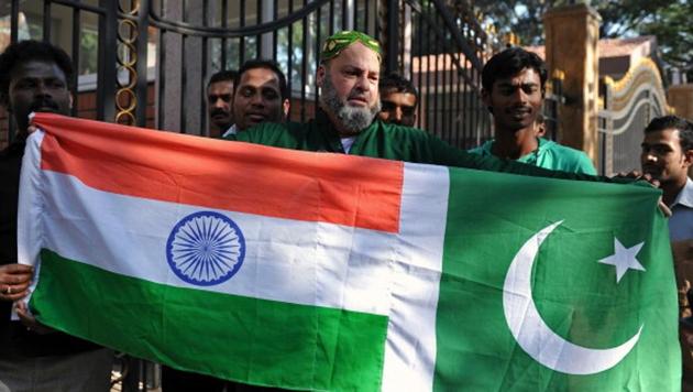 Mohammed Bashir, a 60-year old US-based Pakistani cricket fan, holds up the national flags of India and Pakistan on the eve of a cricket match between the two nations (AFP File Photo) Mohammed Bashir, a 60-year old US-based Pakistani cricket fan, holds up the national flags of India and Pakistan on the eve of a cricket match between the two nations (AFP File Photo)