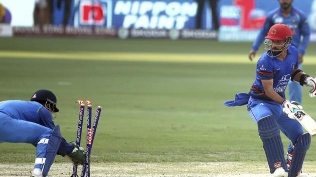 India's Mahendra Singh Dhoni, left, stumps out Afghanistan's Javed Ahmadi, right, during the one day international cricket match. (AP)