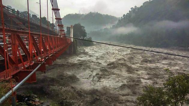 A damaged bridge is seen as flood water gushes into Ravi river during rainfall, in Chamba, on Tuesday. The Indian Meteorological Department (IMD) Tuesday predicted dry weather for Himachal Pradesh from Wednesday onwards, a day after downpours killed 25 people in flashfloods, landslides, roof-collapse and other incidents triggered by incessant rain in north India. Traffic halts on roads leading to Kedarnath, Badrinath temples due to landslides at multiple places since Monday. (PTI) A damaged bridge is seen as flood water gushes into Ravi river during rainfall, in Chamba, on Tuesday. The Indian Meteorological Department (IMD) Tuesday predicted dry weather for Himachal Pradesh from Wednesday onwards, a day after downpours killed 25 people in flashfloods, landslides, roof-collapse and other incidents triggered by incessant rain in north India. Traffic halts on roads leading to Kedarnath, Badrinath temples due to landslides at multiple places since Monday. (PTI)