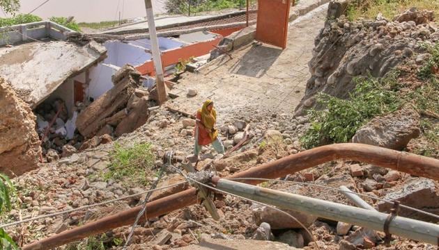 A temple lies in ruins due to landslides followed by heavy rains in Jammu.(PTI)