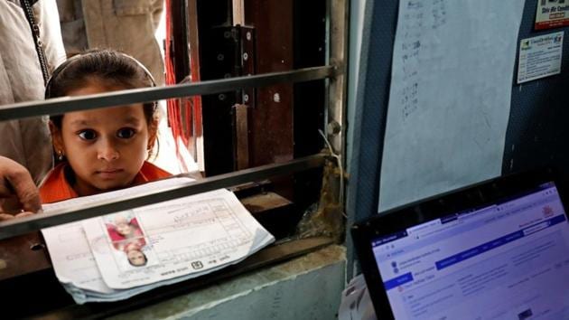A girl waits for her turn to enrol for the Unique Identification database system, also known as Aadhaar, at a registration centre in New Delhi.(REUTERS File)