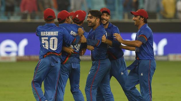 Afghan cricketers celebrate after the game against India ended in a tie on Tuesday.(AFP)