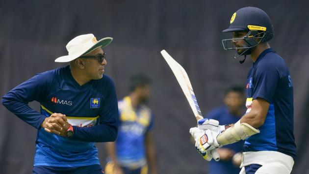 Sri Lanka'S Dasun Shanaka (R) and coach Chandika Hathurusingha (L) speak during a training session at the Pallekele International Cricket Stadium(AFP)